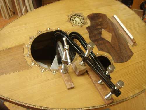 Re-gluing a top brace on the oud.