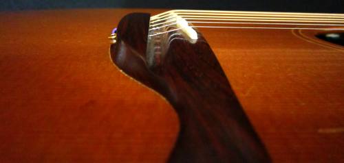 Action was lowered at the 12th fret, and the saddle raised to create a steeper break angle so the strings could drive the top and deliver great sound. 