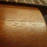 Crack in the ukulele top next to the fingerboard.